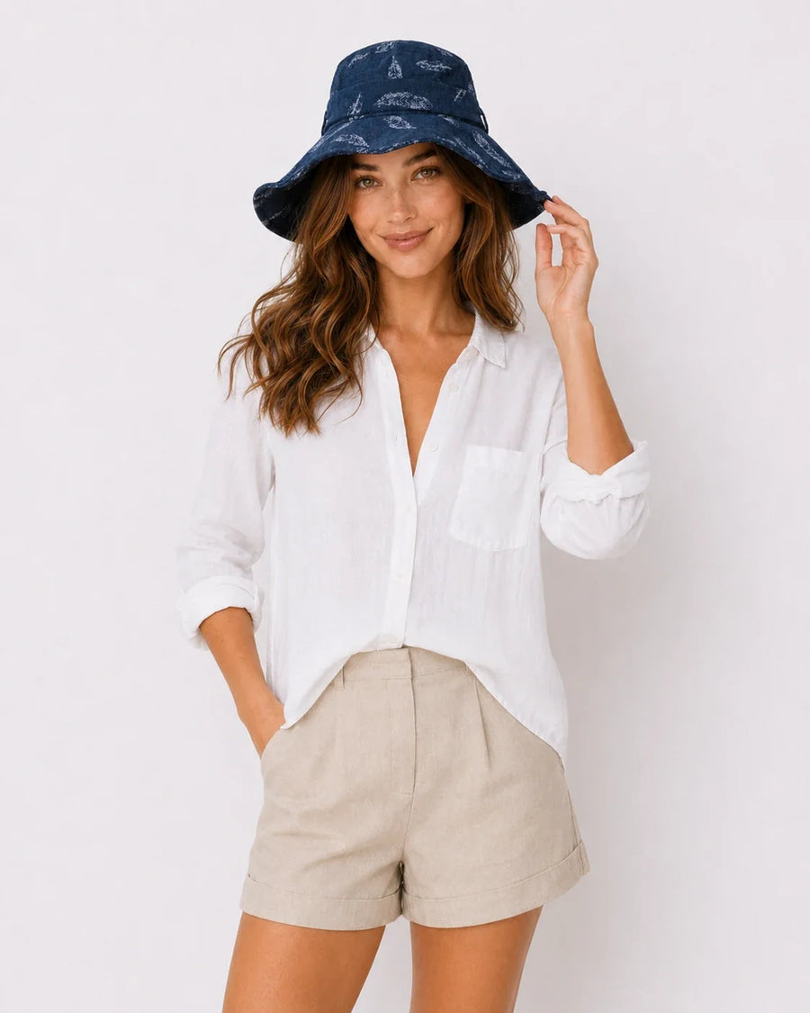 Woman wearing a navy bucket hat, introducing a guide to women's hat types