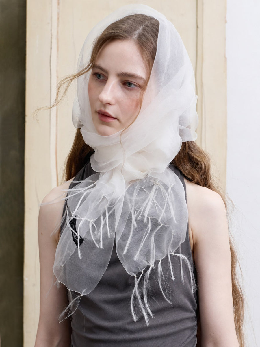 Sheer white mulberry silk organza scarf styled as a headscarf with hand-knotted fringe