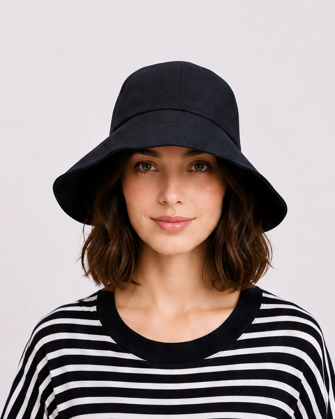 Woman wearing black linen wide brim sun hat, front view