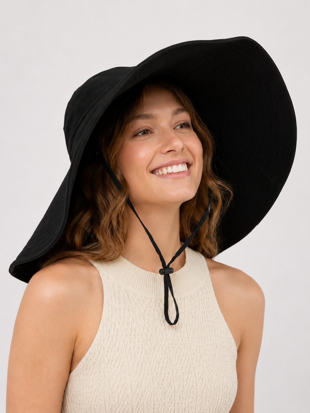 Black wide-brim sun hat with windproof cord on model