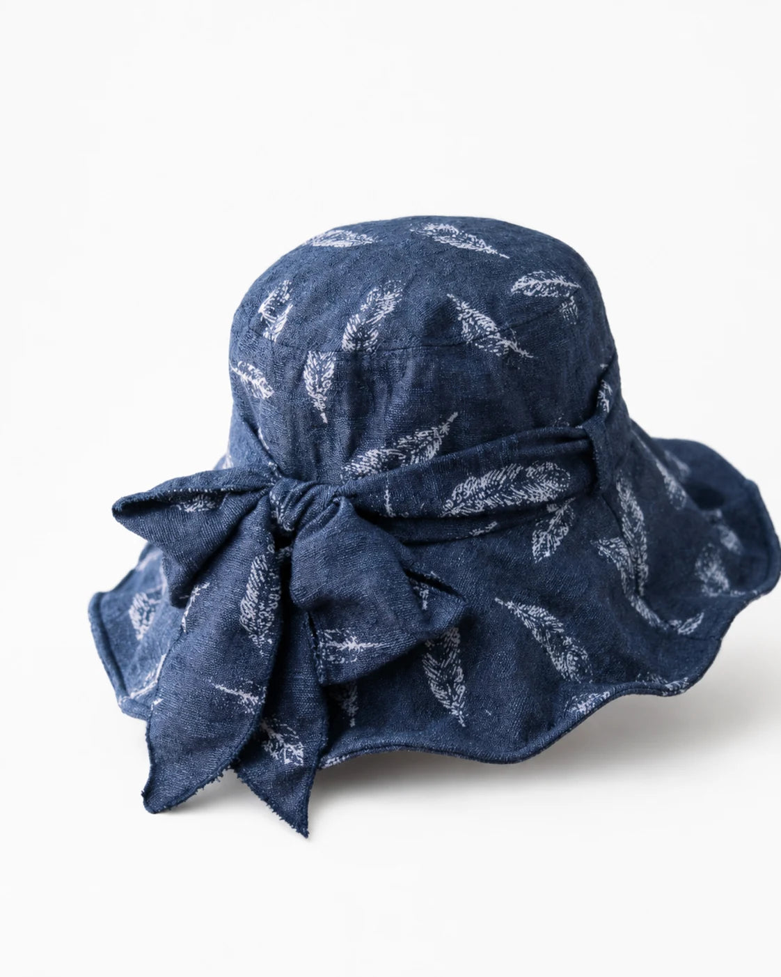 Navy feather-print bucket hat with back bow detail