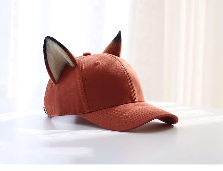 Rust-orange fox ear baseball cap shown from a three-quarter angle