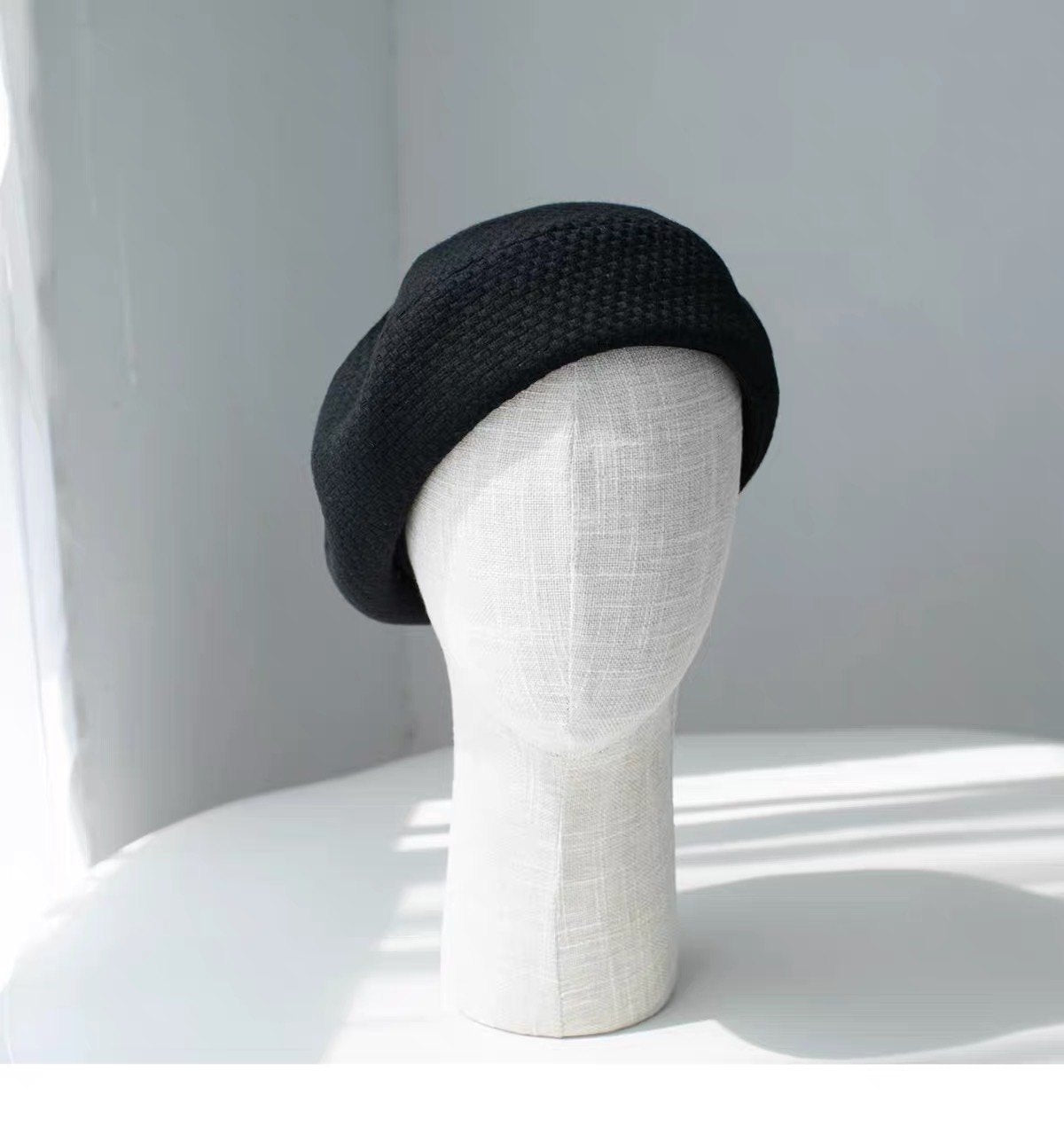 Black structured wool beret shown from the front left
