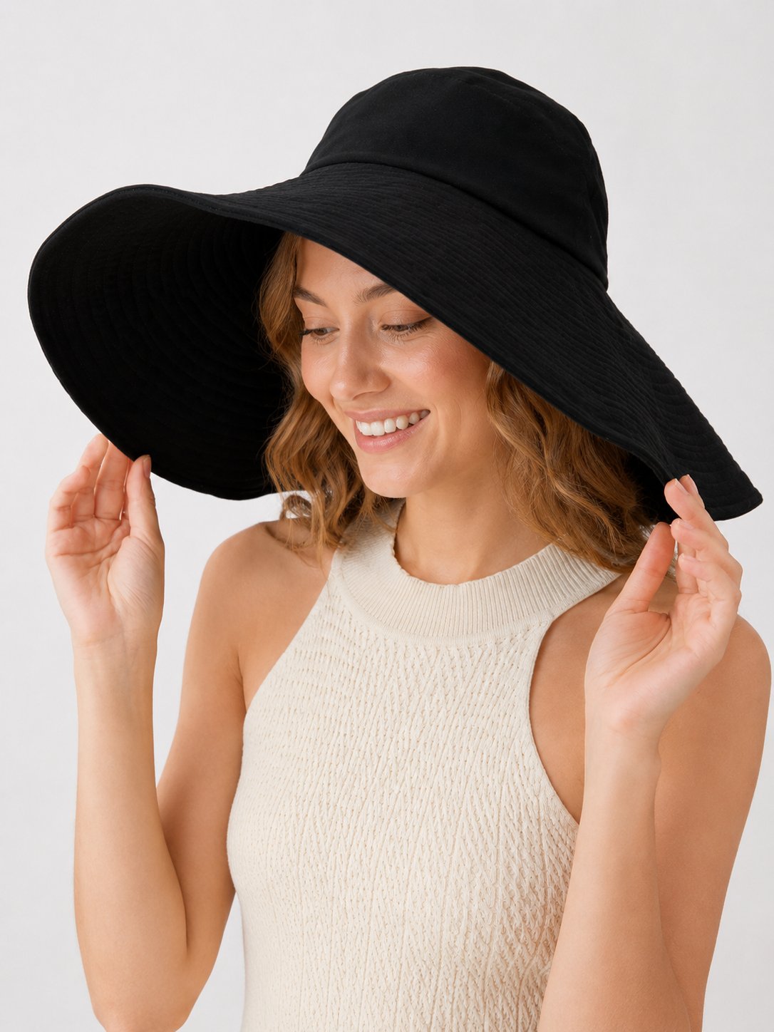 Model in black 15cm wide-brim cotton sun hat, angled view