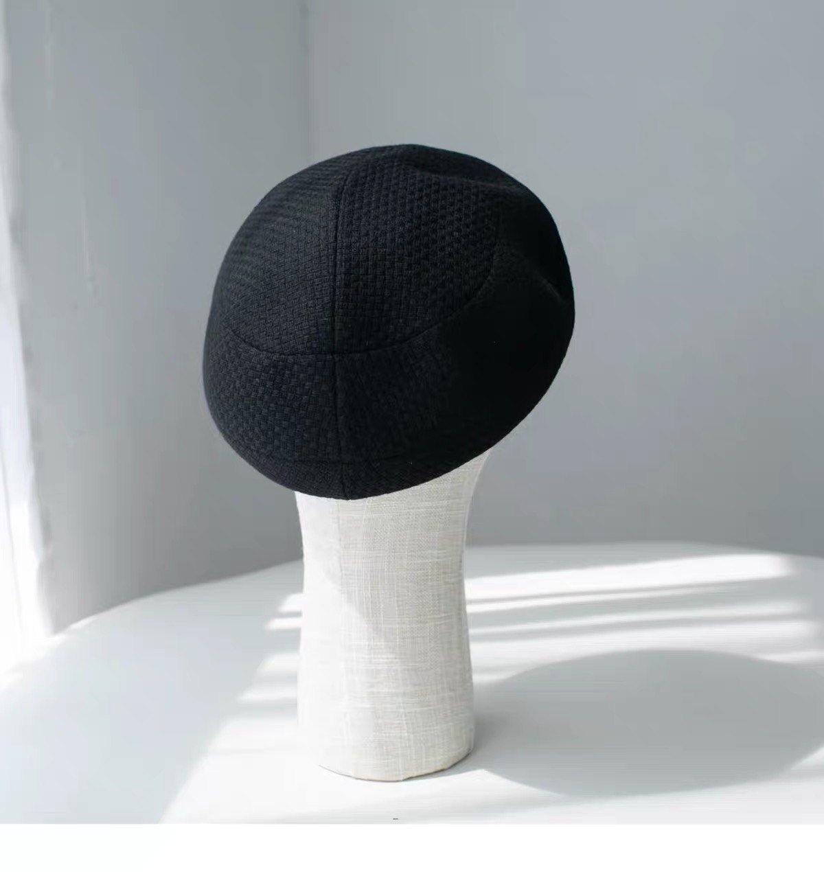 Rear view of the black structured wool beret