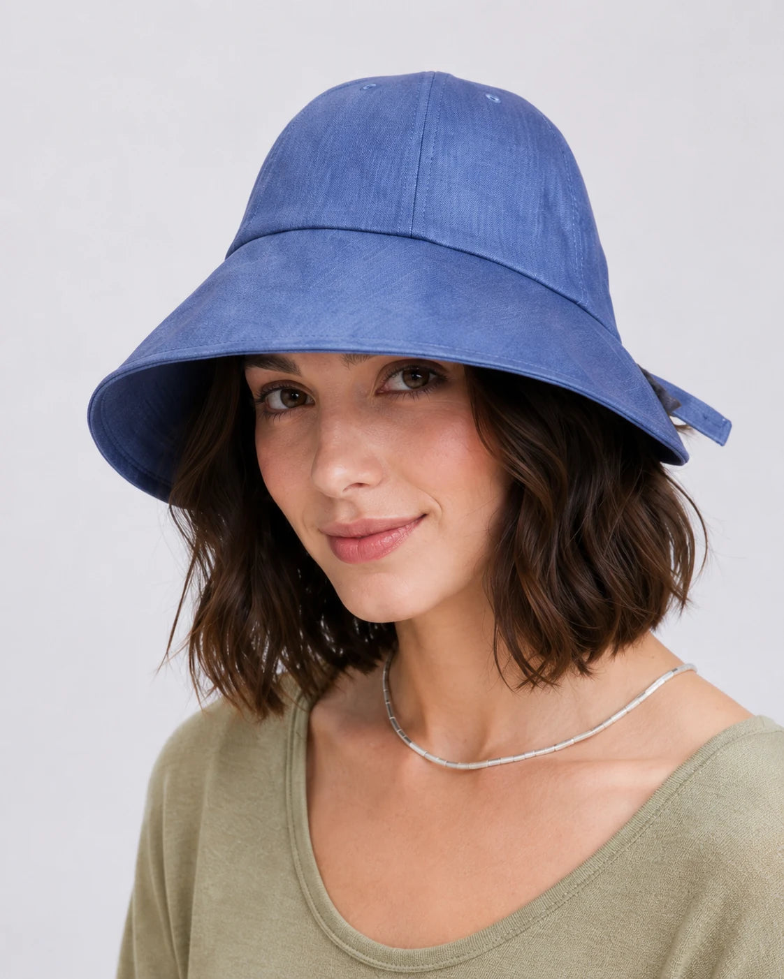 Woman wearing dark blue linen wide brim sun hat, front view
