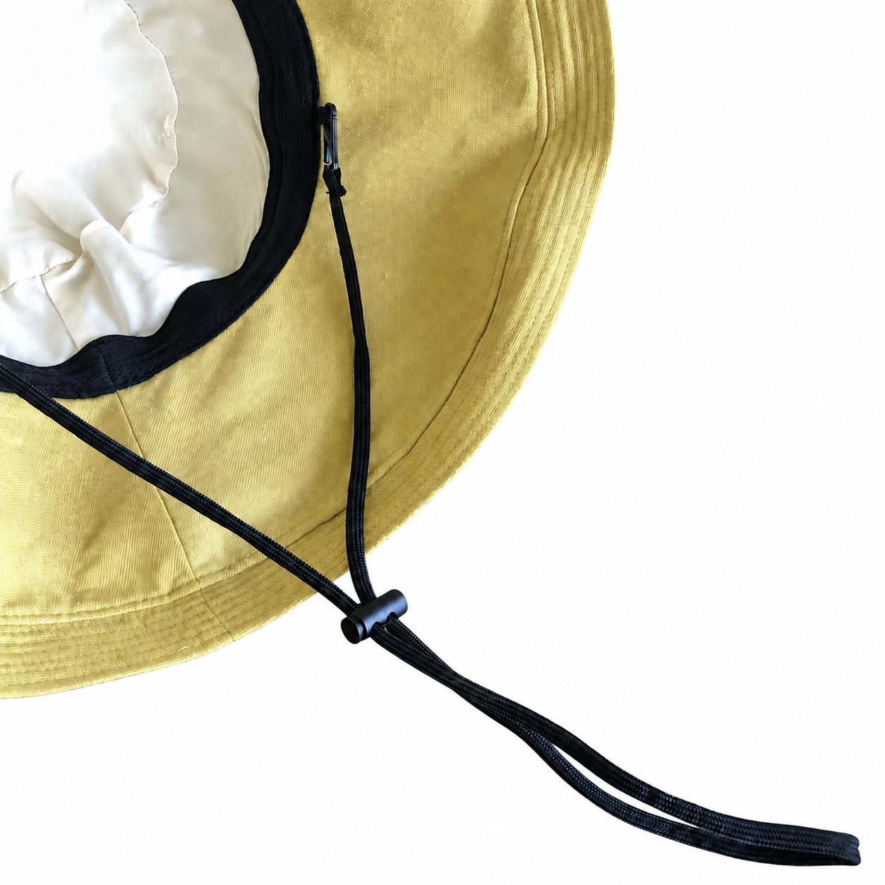 Close-up of adjustable black drawstring chin cord on yellow bucket hat