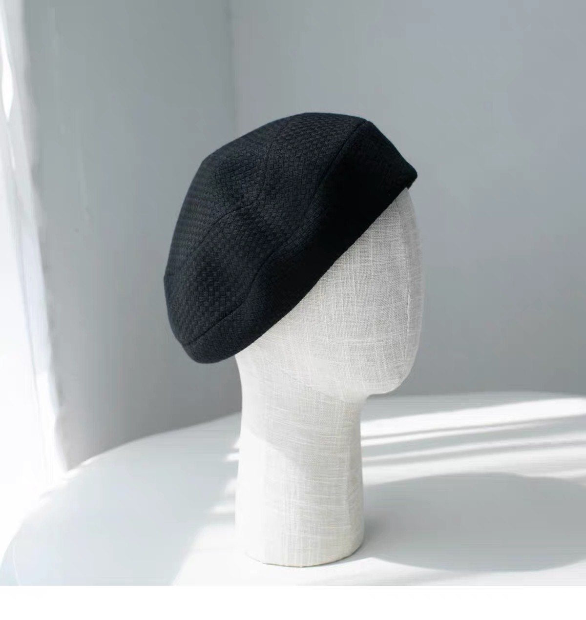 Black structured wool beret shown from the right side