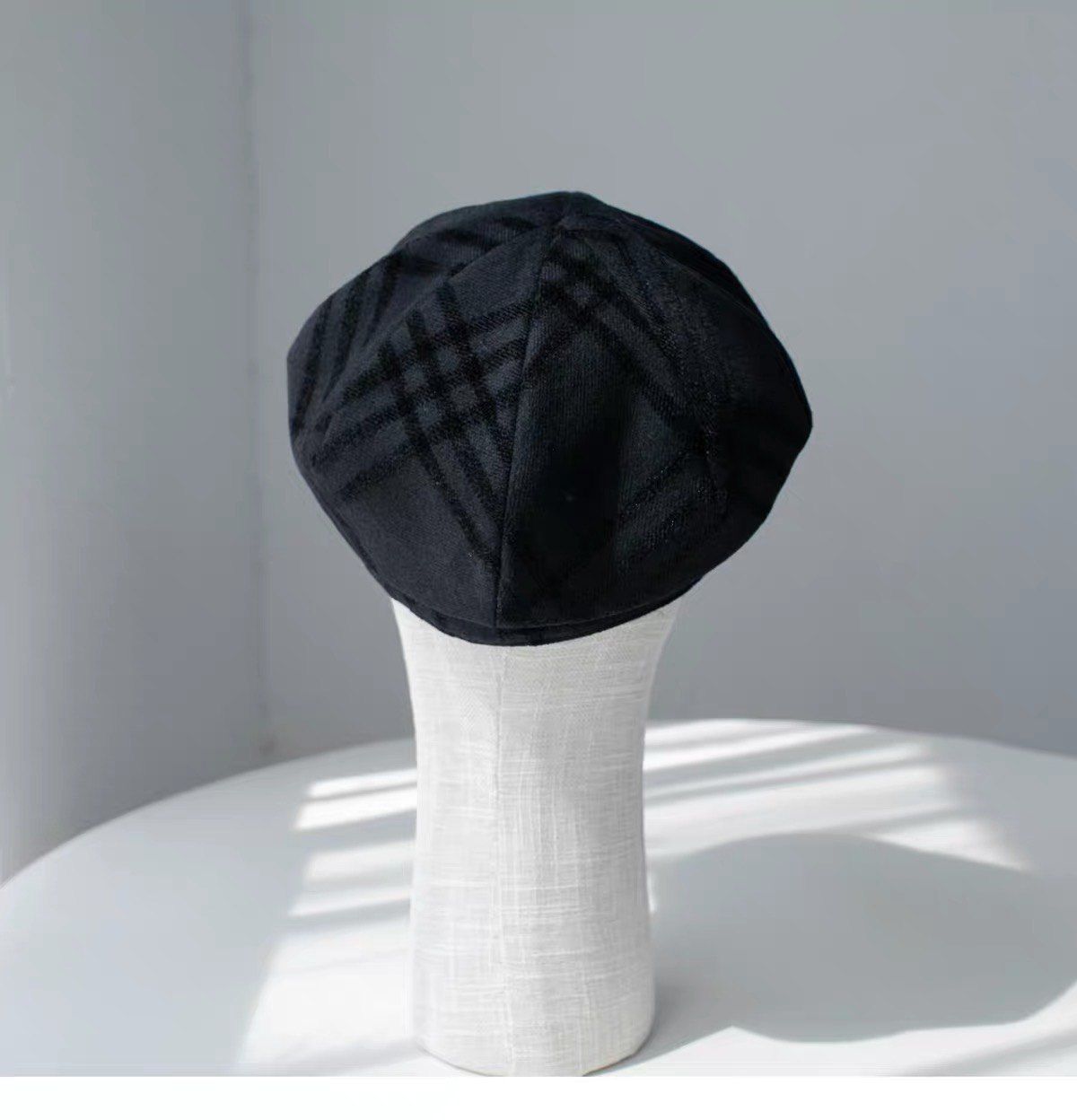 Rear view of the black fine woven wool newsboy cap