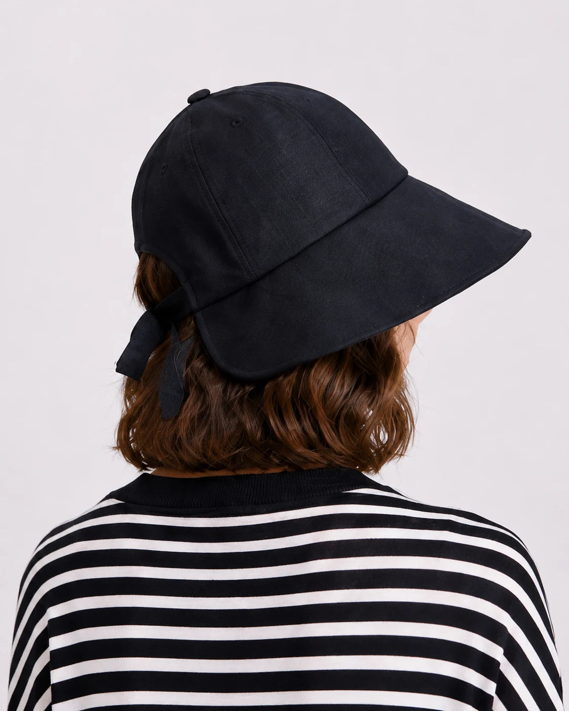 Back view of linen sun hat showing bow and buckle adjuster