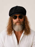 Man wearing black linen newsboy baker boy cap
