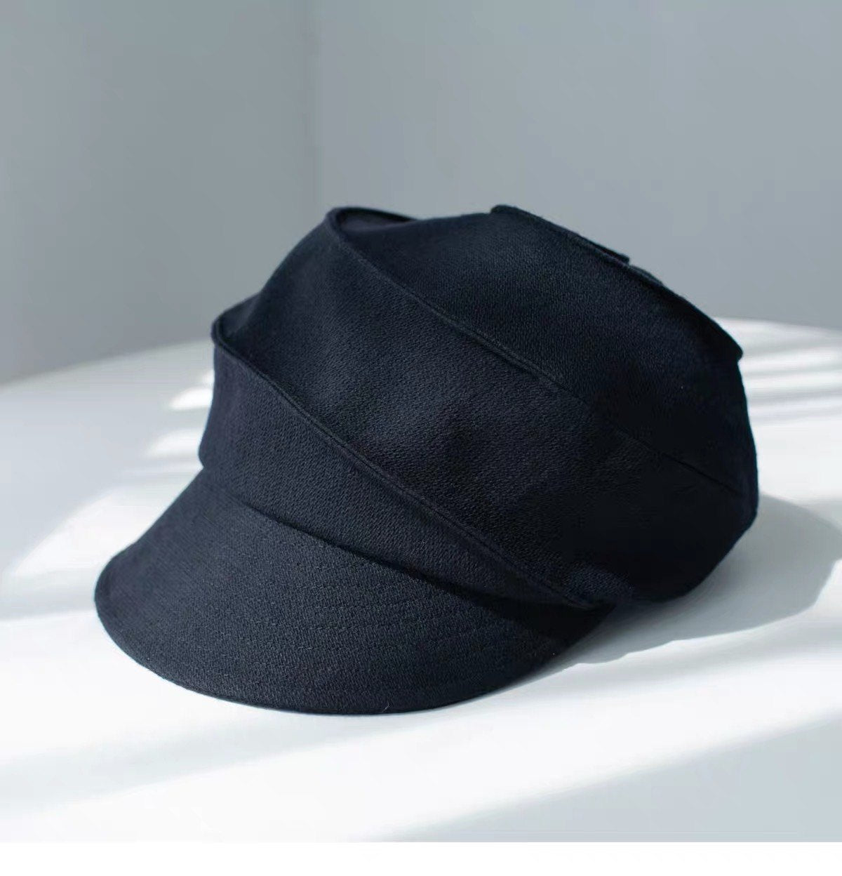 Navy sculpted wool newsboy cap, three-quarter product view