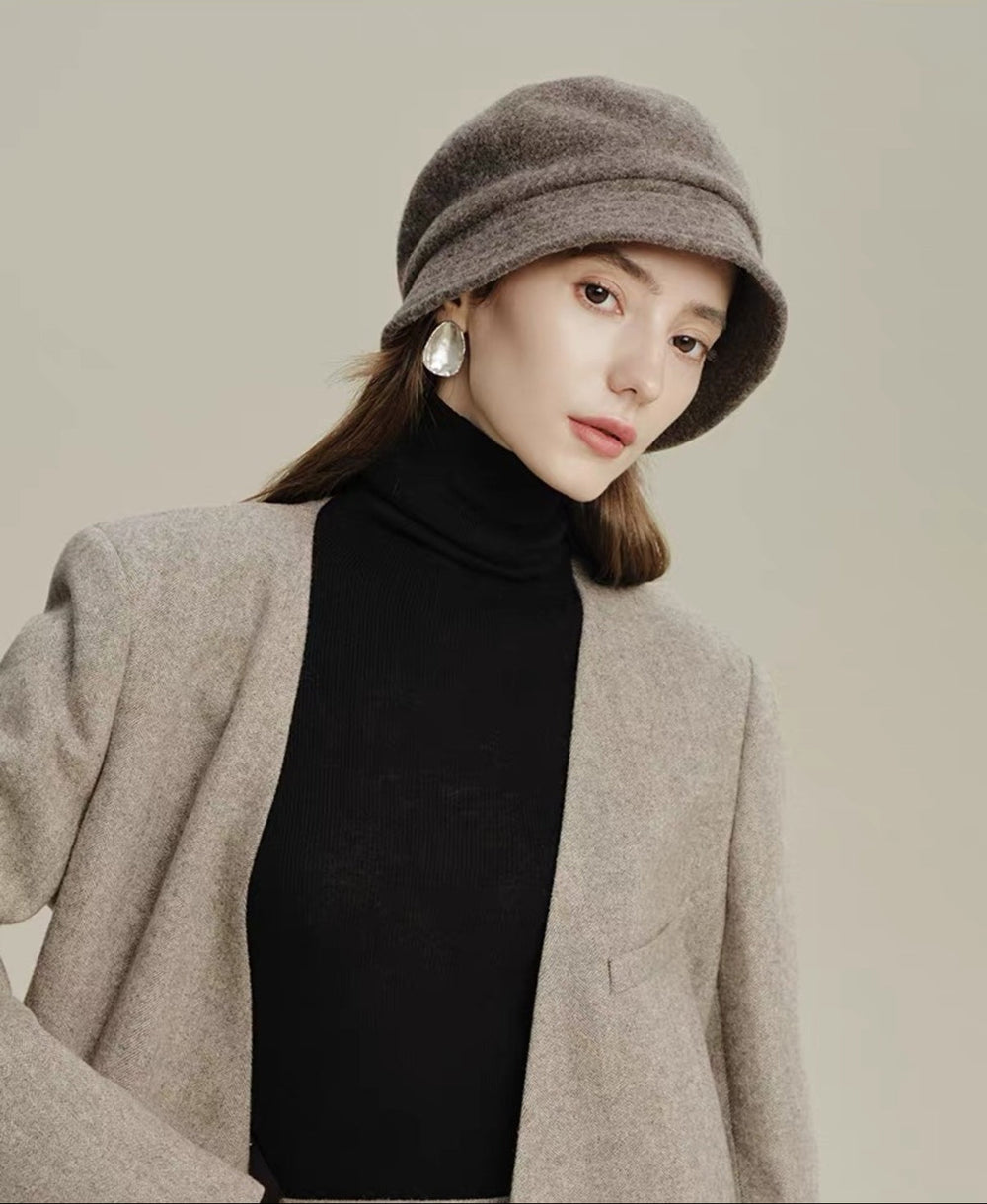 Taupe 100% wool cloche hat worn by a woman in a tailored winter outfit