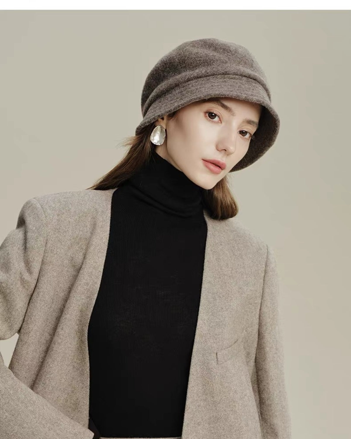 Taupe 100% wool cloche hat worn by a woman in a tailored winter outfit