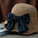 Close-up of camel straw hat with large black bow detail