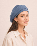 Woman wearing blue cotton linen French beret