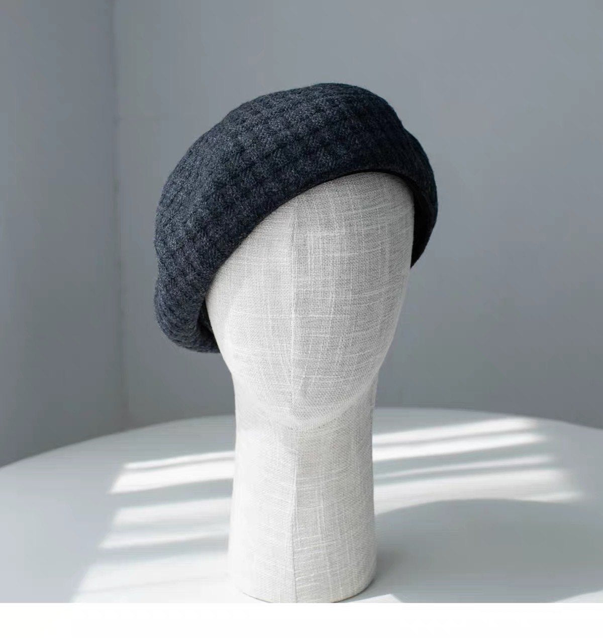 Charcoal gray structured wool beret shown from the front left