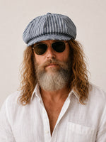 Man wearing blue striped linen newsboy cap