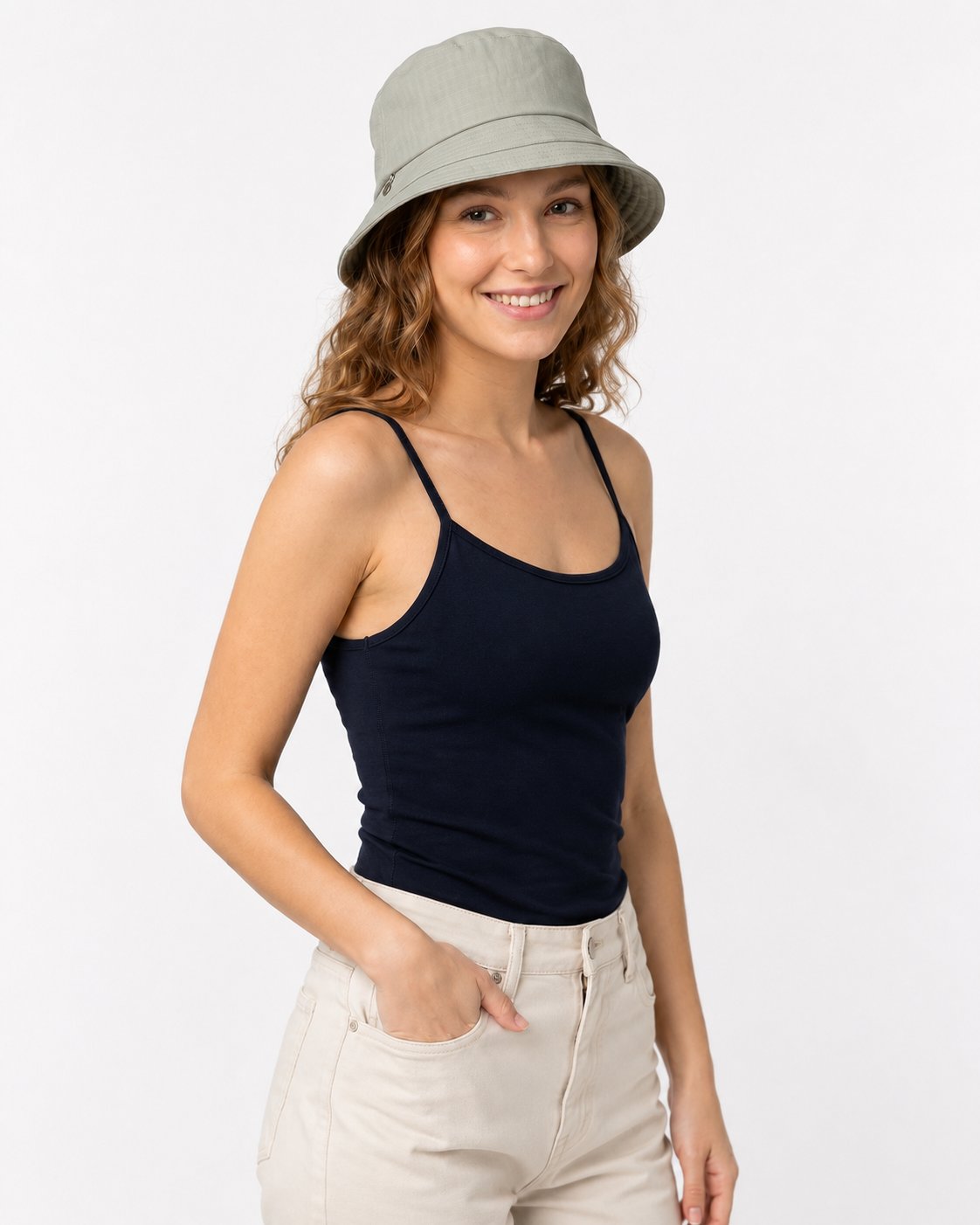 Woman wearing sage green cotton sun hat with navy top, front view