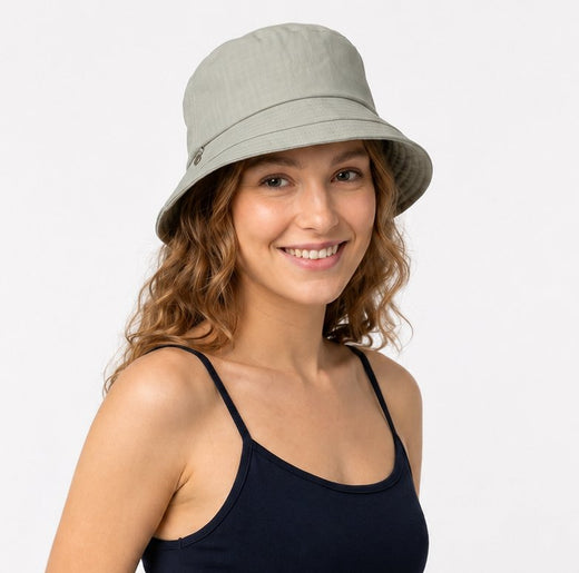 Woman wearing sage green cotton sun hat with navy top, front view