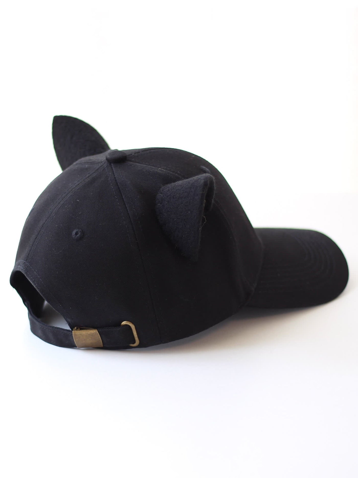 Back view of black animal-ear baseball cap with adjustable strap and metal slider