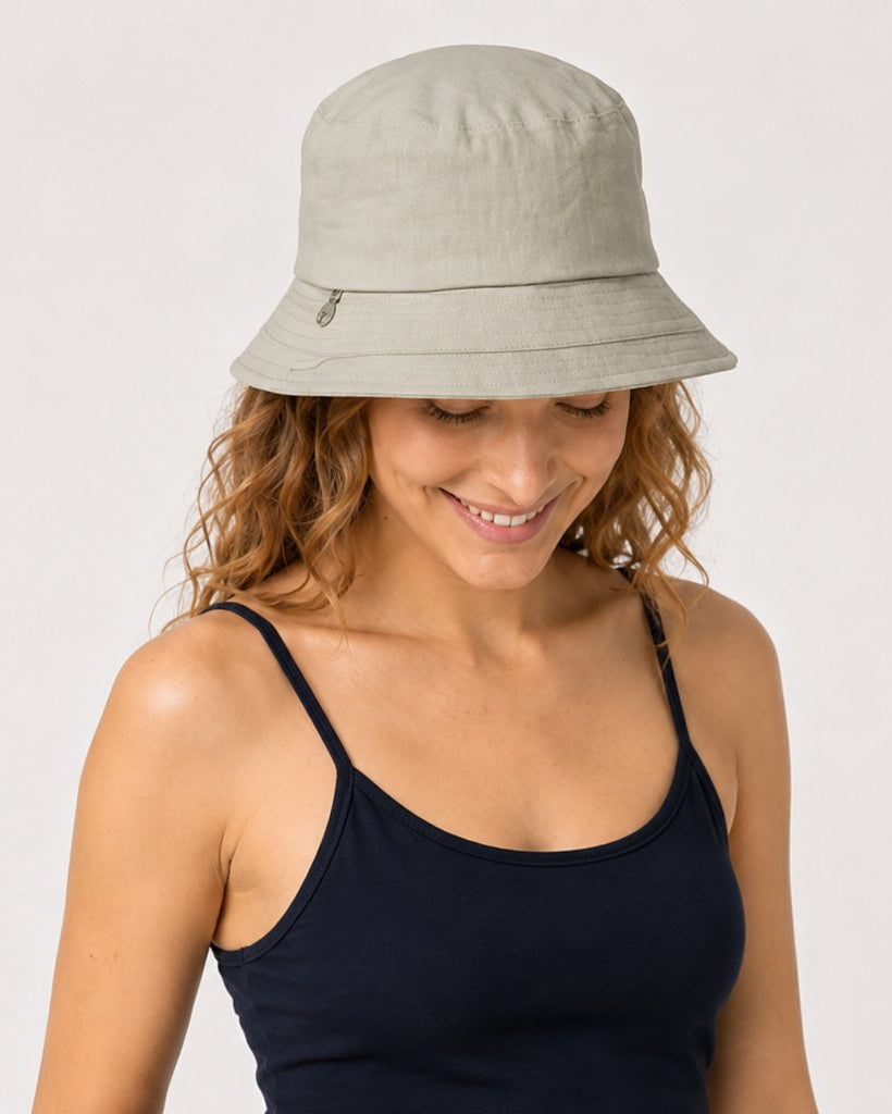 Sage green cotton bucket sun hat on model looking down