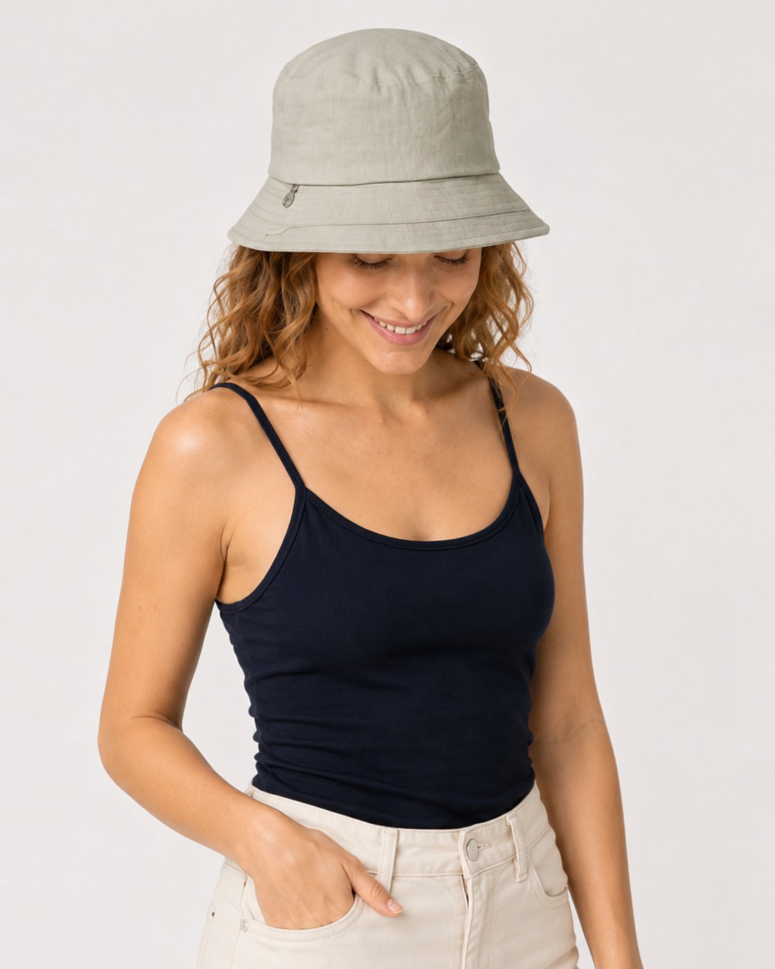 Sage green cotton bucket sun hat on model looking down
