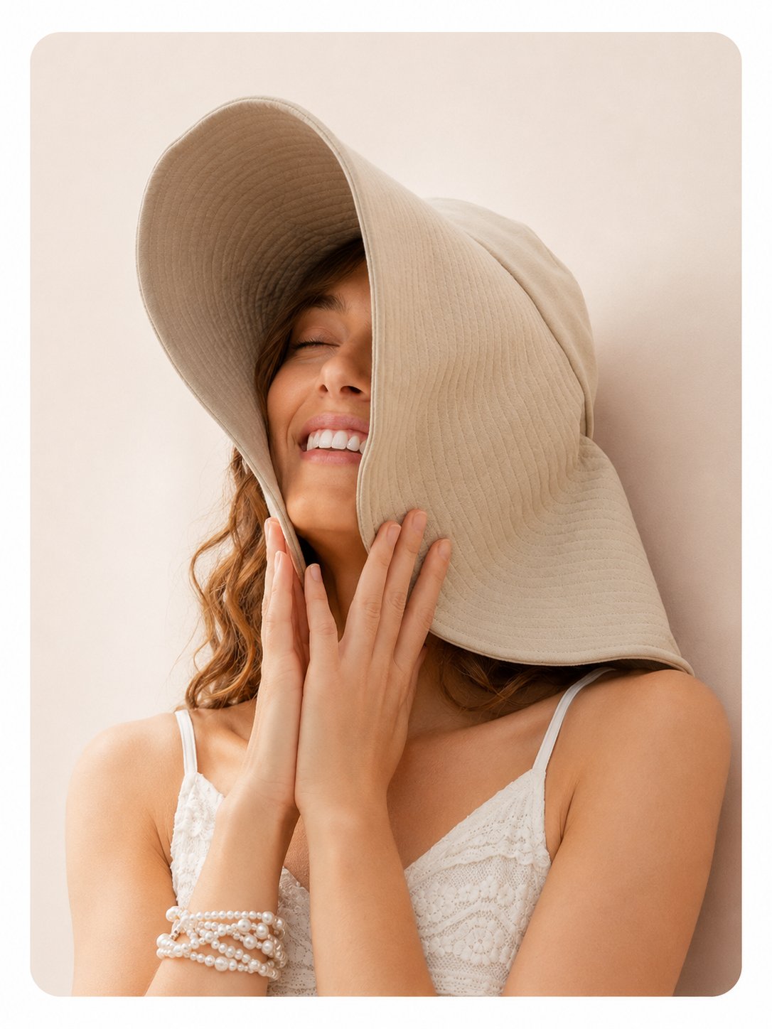 Woman in cream wide-brim sun hat, front view