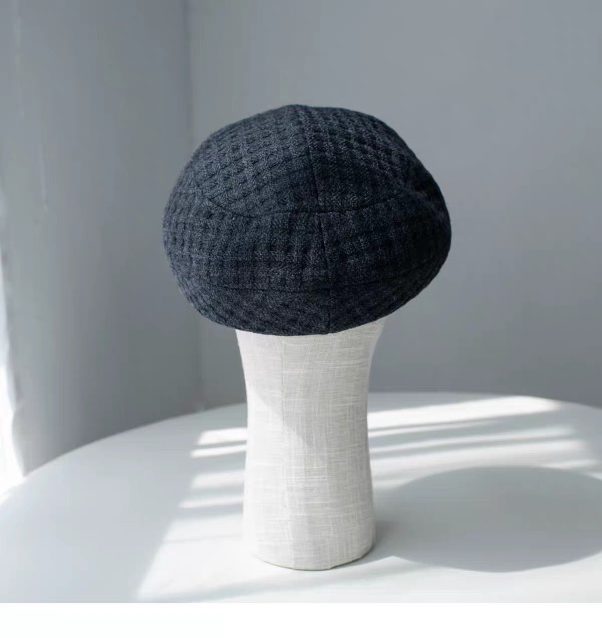 Rear view of the charcoal gray structured wool beret