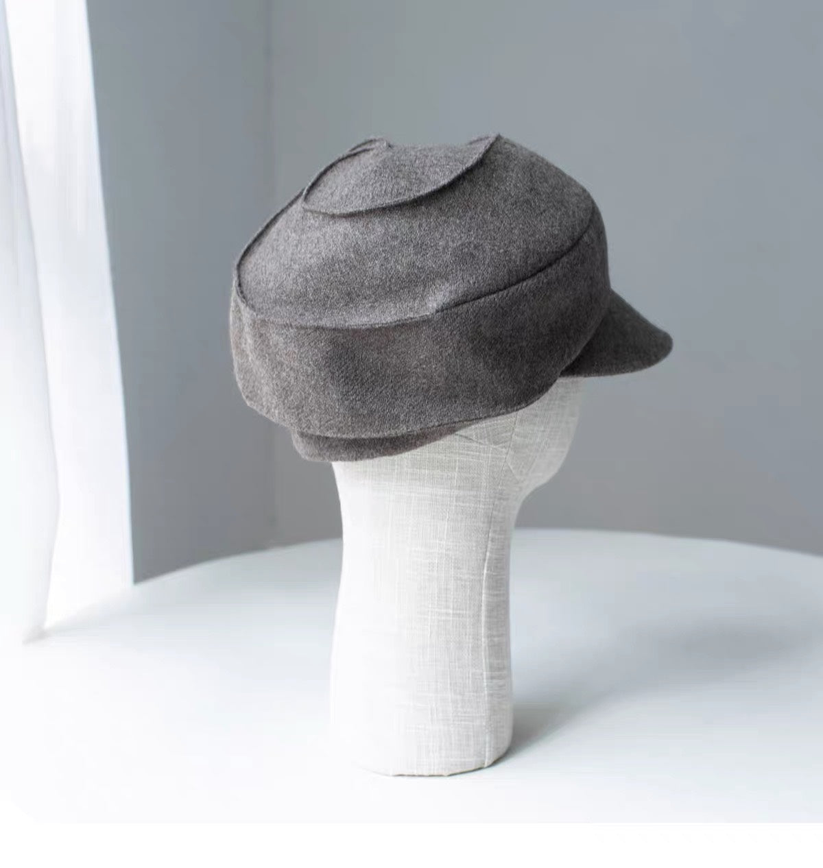 Khaki sculpted wool newsboy cap shown from the right rear