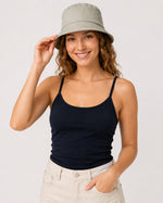 Close front view of model in sage green cotton sun hat