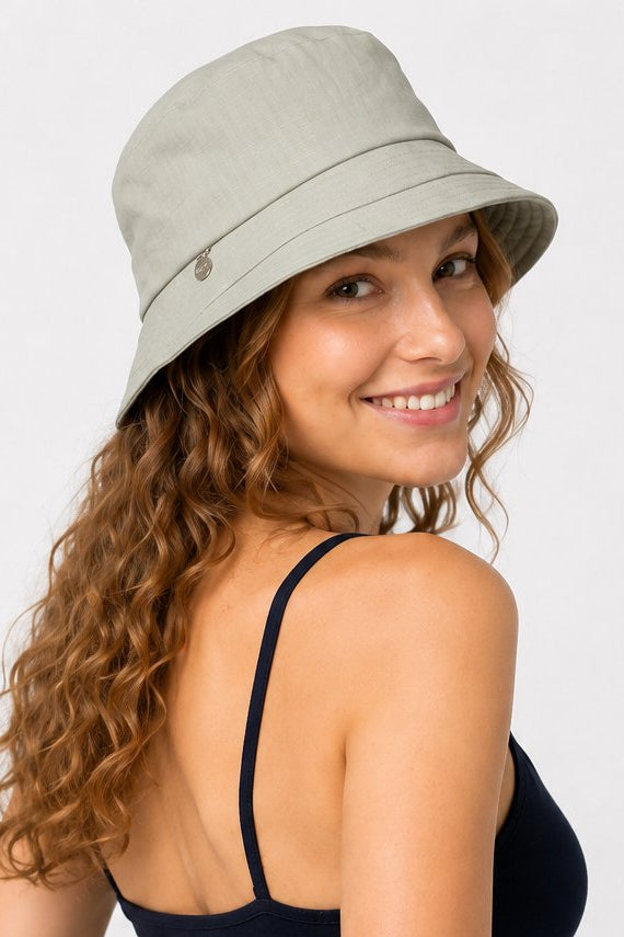 Side back view of woman in sage green cotton sun hat