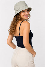 Side back view of woman in sage green cotton sun hat