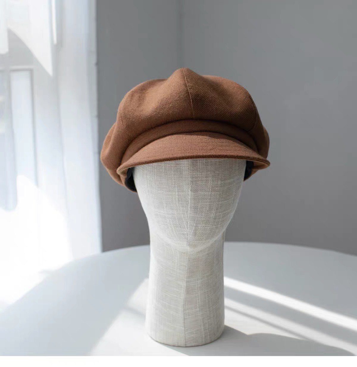 Brown fine woven wool newsboy cap shown from the front