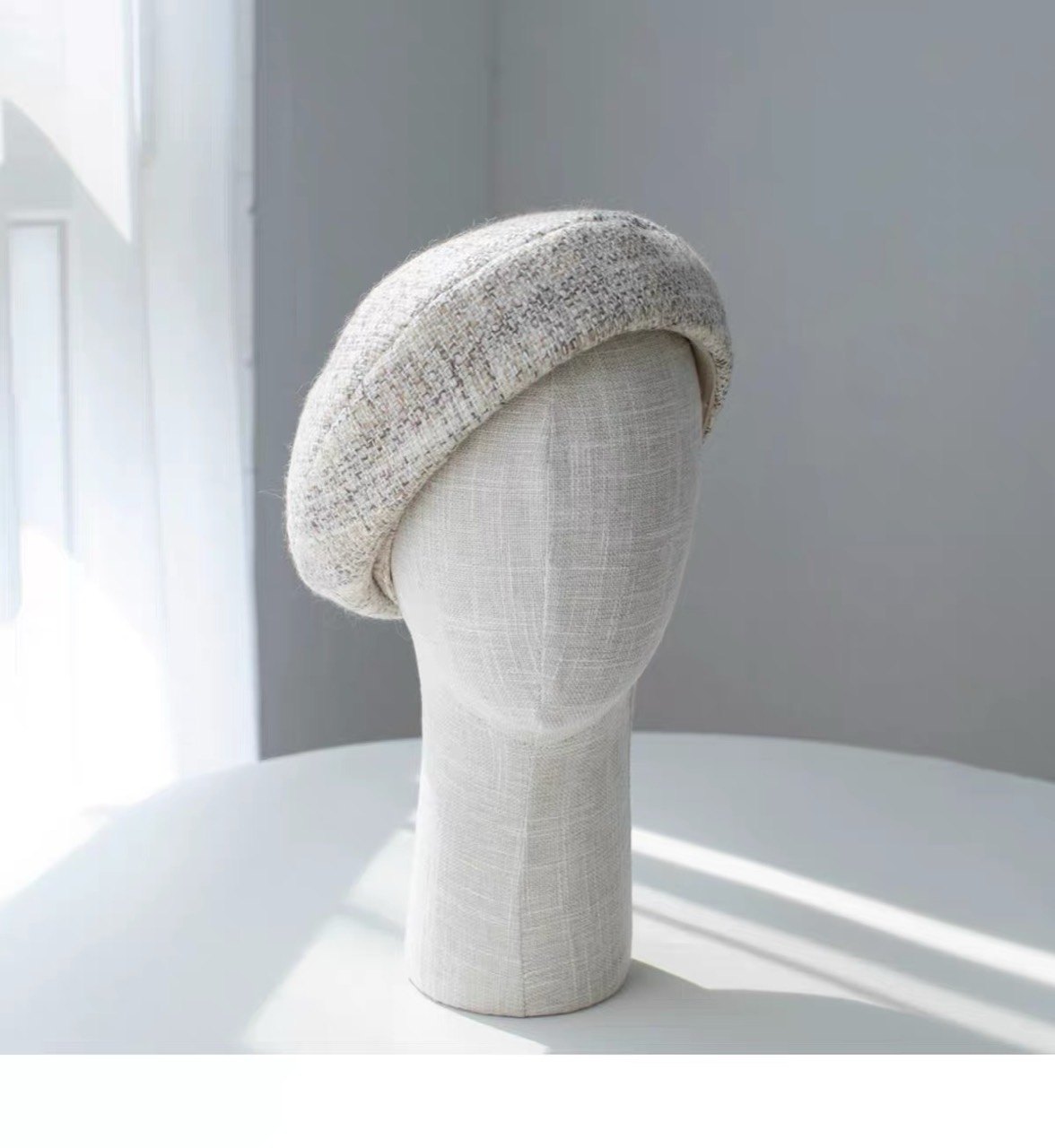 Beige structured wool beret shown from the front left