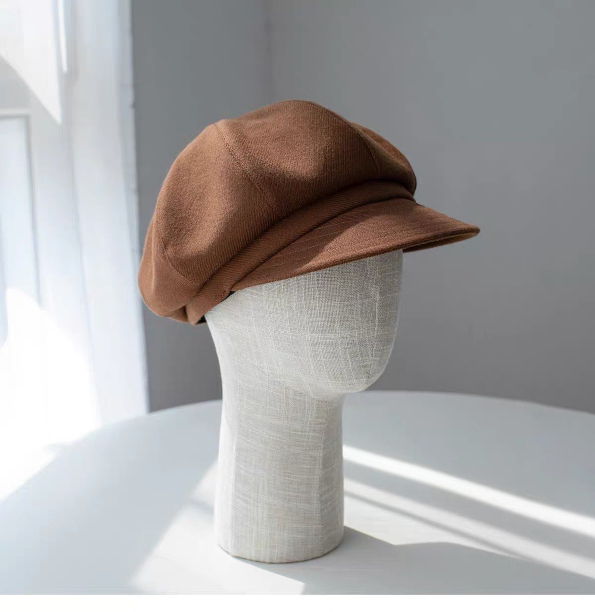 Brown fine woven wool newsboy cap shown from the right front