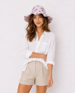 Woman wearing pink feather-print bucket hat