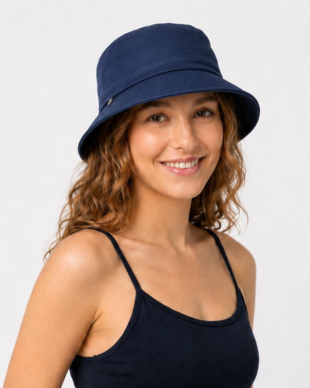 Woman wearing navy cotton sun hat with navy top, front view