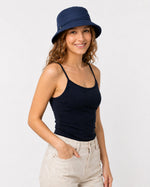 Woman wearing navy cotton sun hat with navy top, front view