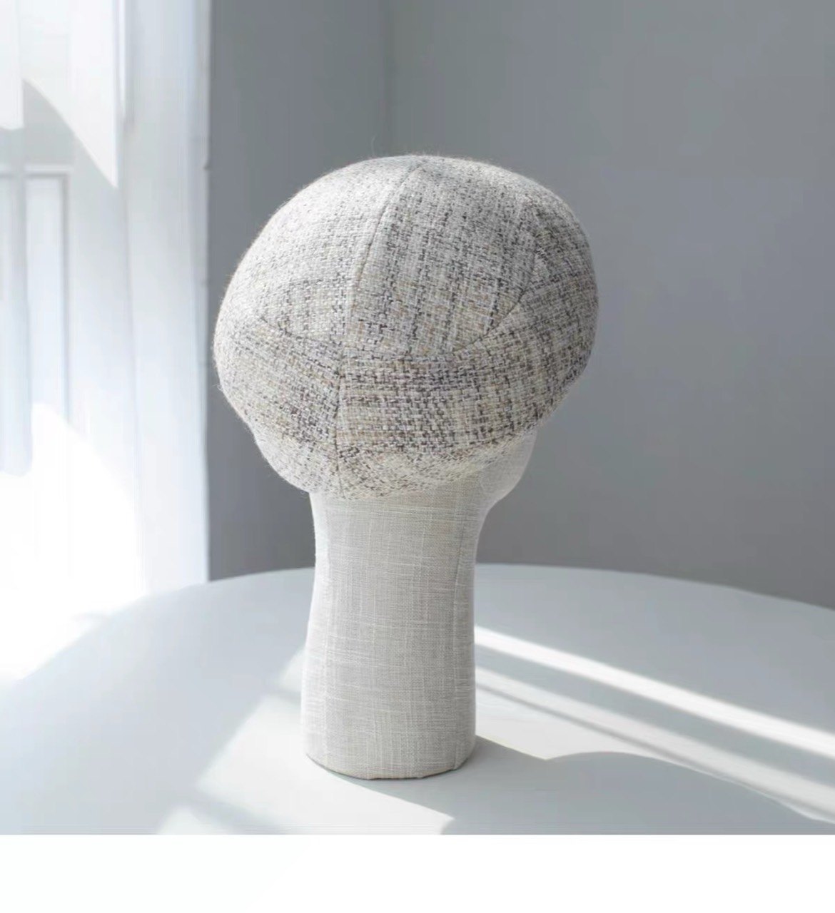Rear view of the beige structured wool beret