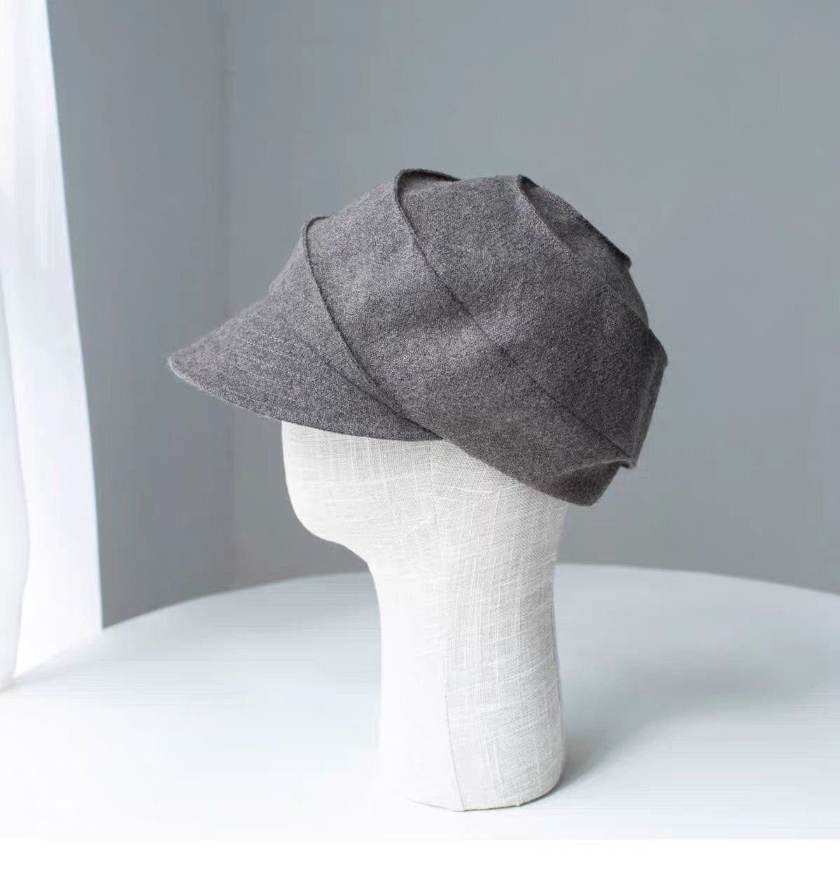 Khaki sculpted wool newsboy cap shown from the left side