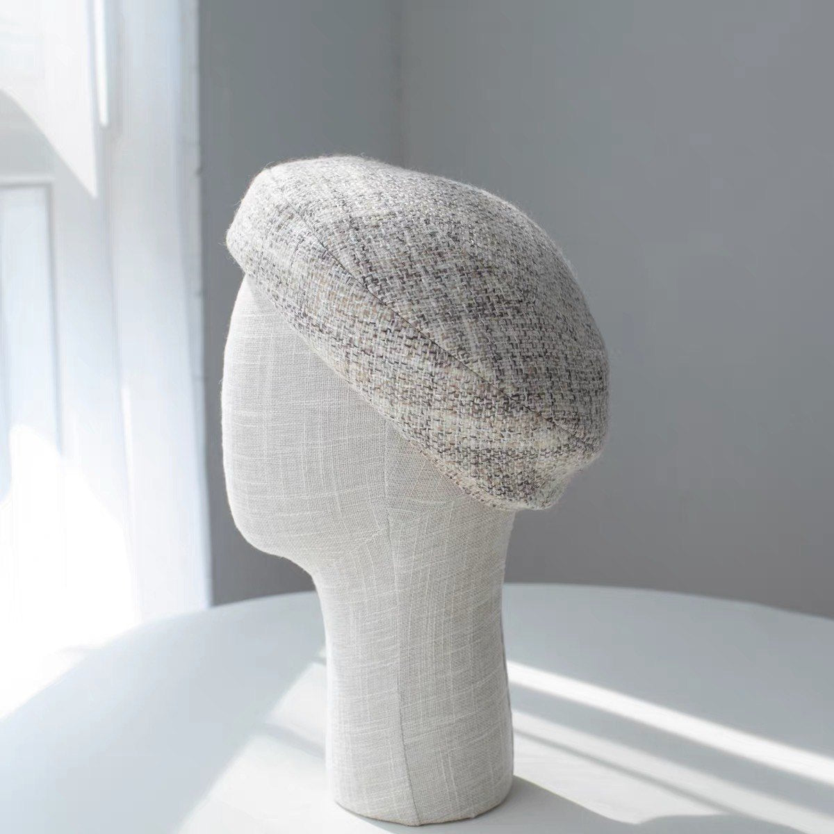 Beige structured wool beret shown from the left side