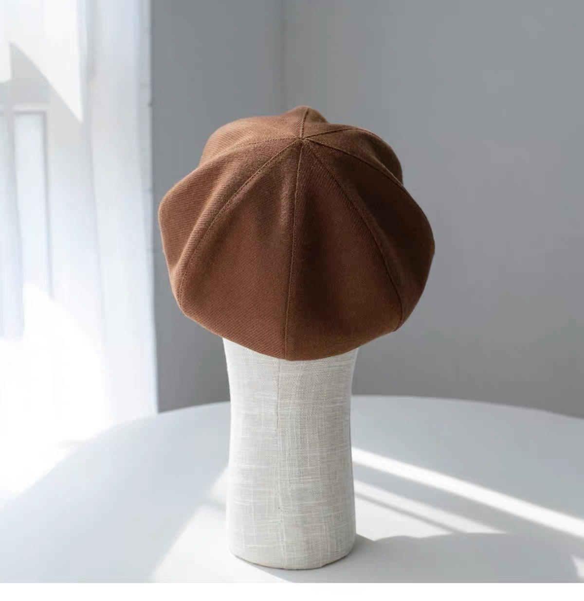 Brown fine woven wool newsboy cap shown from the left side