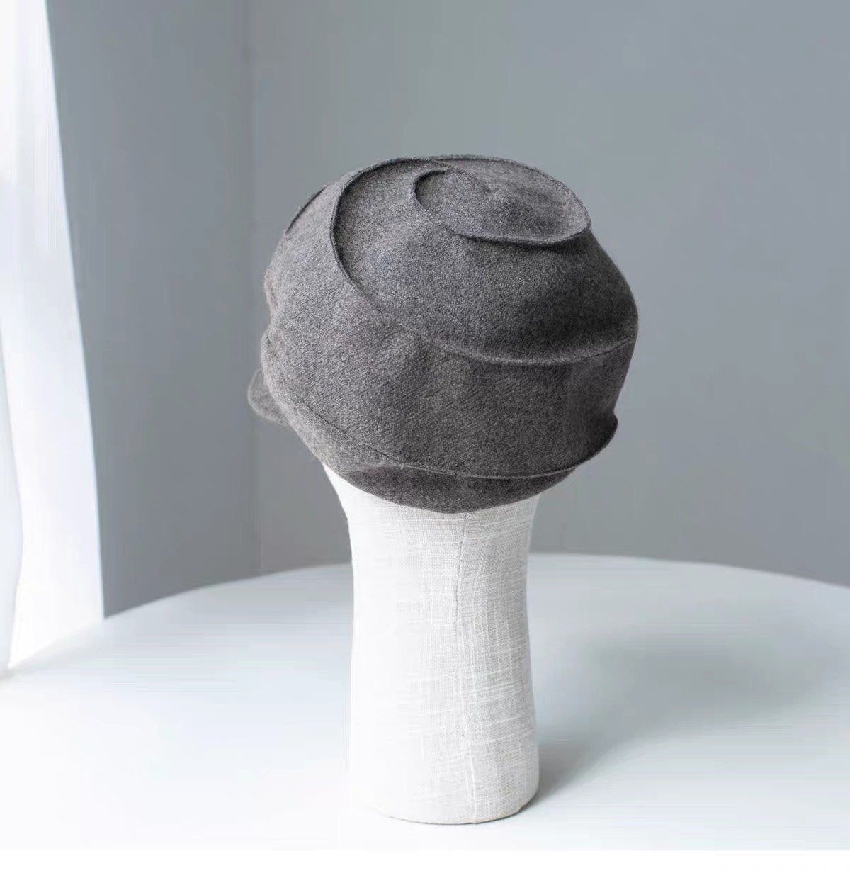 Rear and top view of the khaki wool newsboy cap's curved panel construction