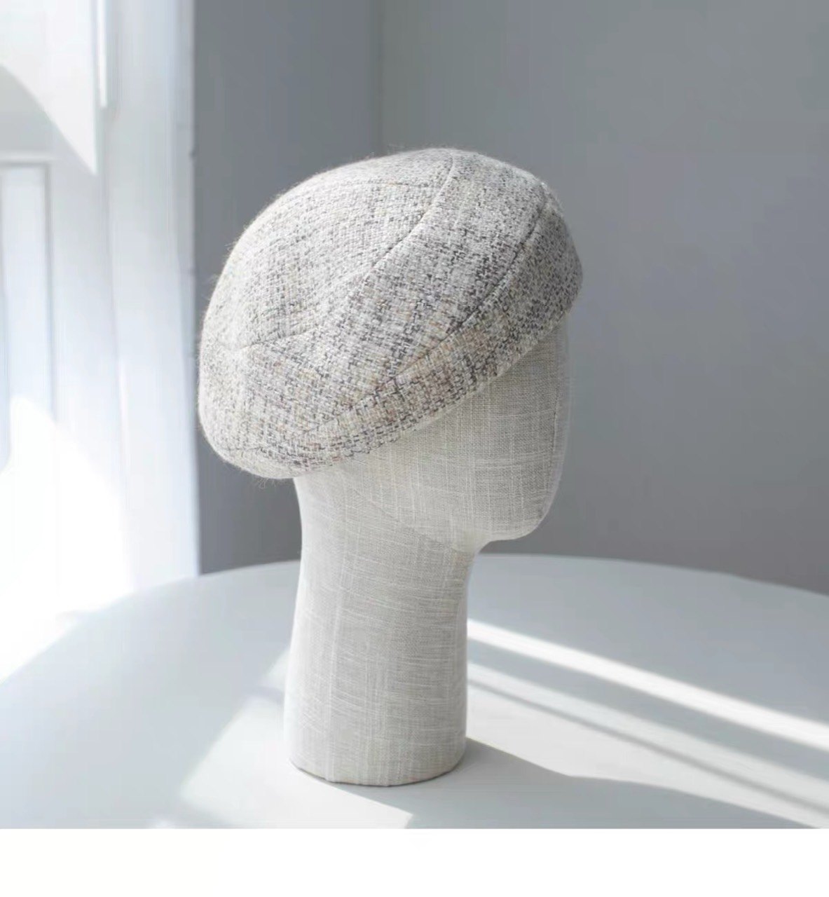 Beige structured wool beret shown from the right side