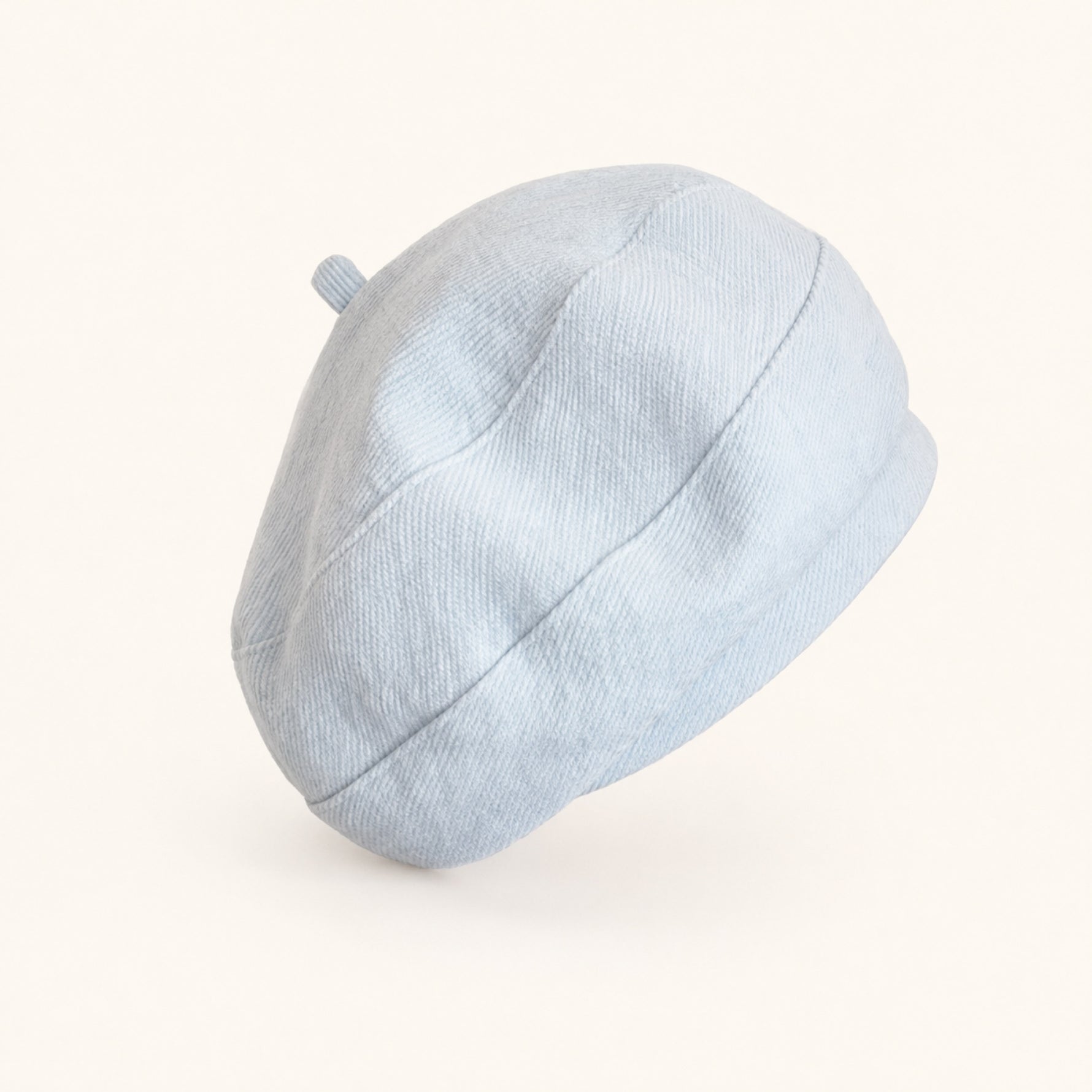 Woman wearing light blue cotton linen French beret