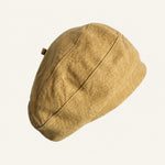 Woman wearing yellow cotton linen French beret