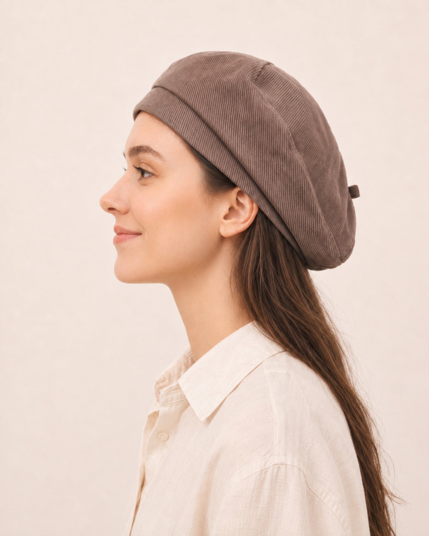 Woman wearing taupe cotton linen French beret
