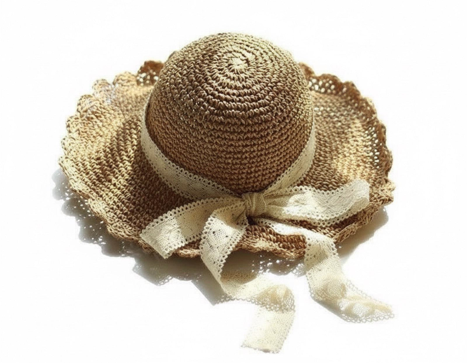 Brown scalloped straw hat with lace bow, top-down view on white background