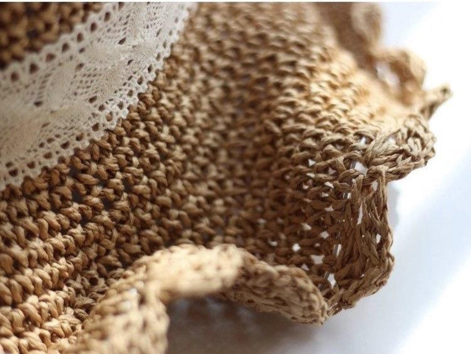 Close-up of hand-woven straw weave texture and scalloped edge detail